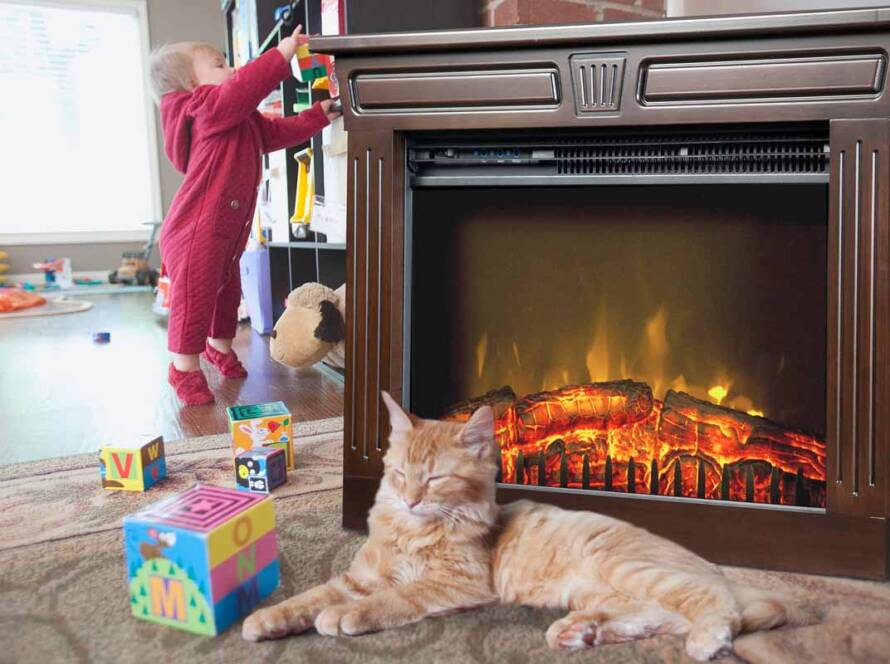 Cat resting near an Amish Fireplace with a toddler playing in the background